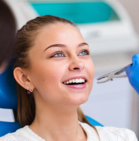 Smiling woman at a dental appointment, ready for examination.