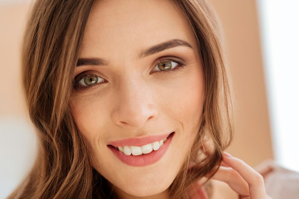 Smiling woman showing bright teeth after a dental visit with Dr. Boris at dental clinic in Evanston.