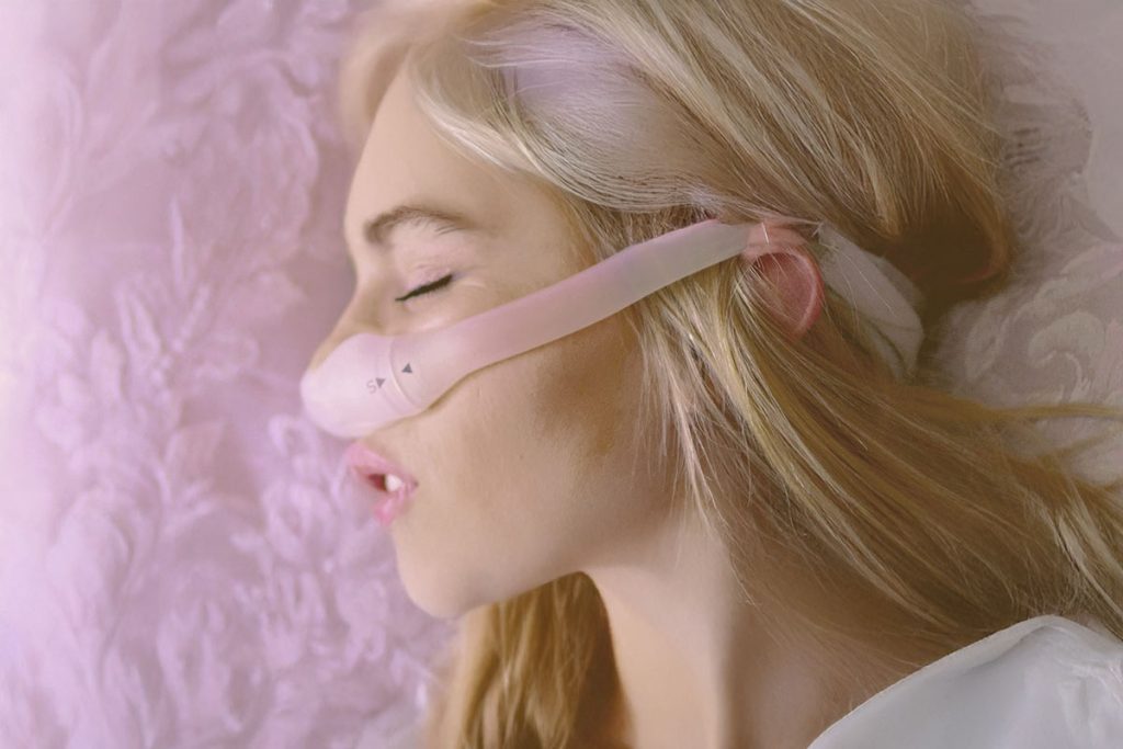 A person sleeping with snoring and sleep apnea device provided by Dr. Boris.