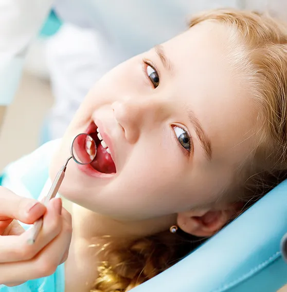 Young girl getting a dental check-up, guided by Dr. Boris Kaltchev's orthodontic expertise.
